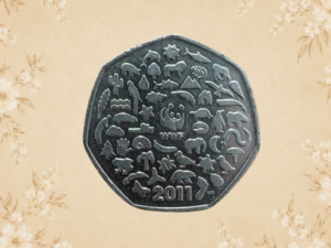 Vintage British 50p coin showing the detailed reverse design, photographed on a soft vintage floral background.