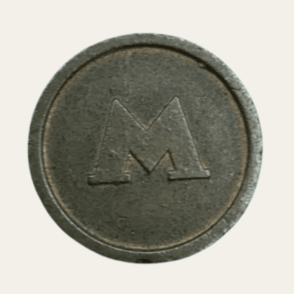 1990s Kyiv Metro token showing the stylised Metro M symbol
