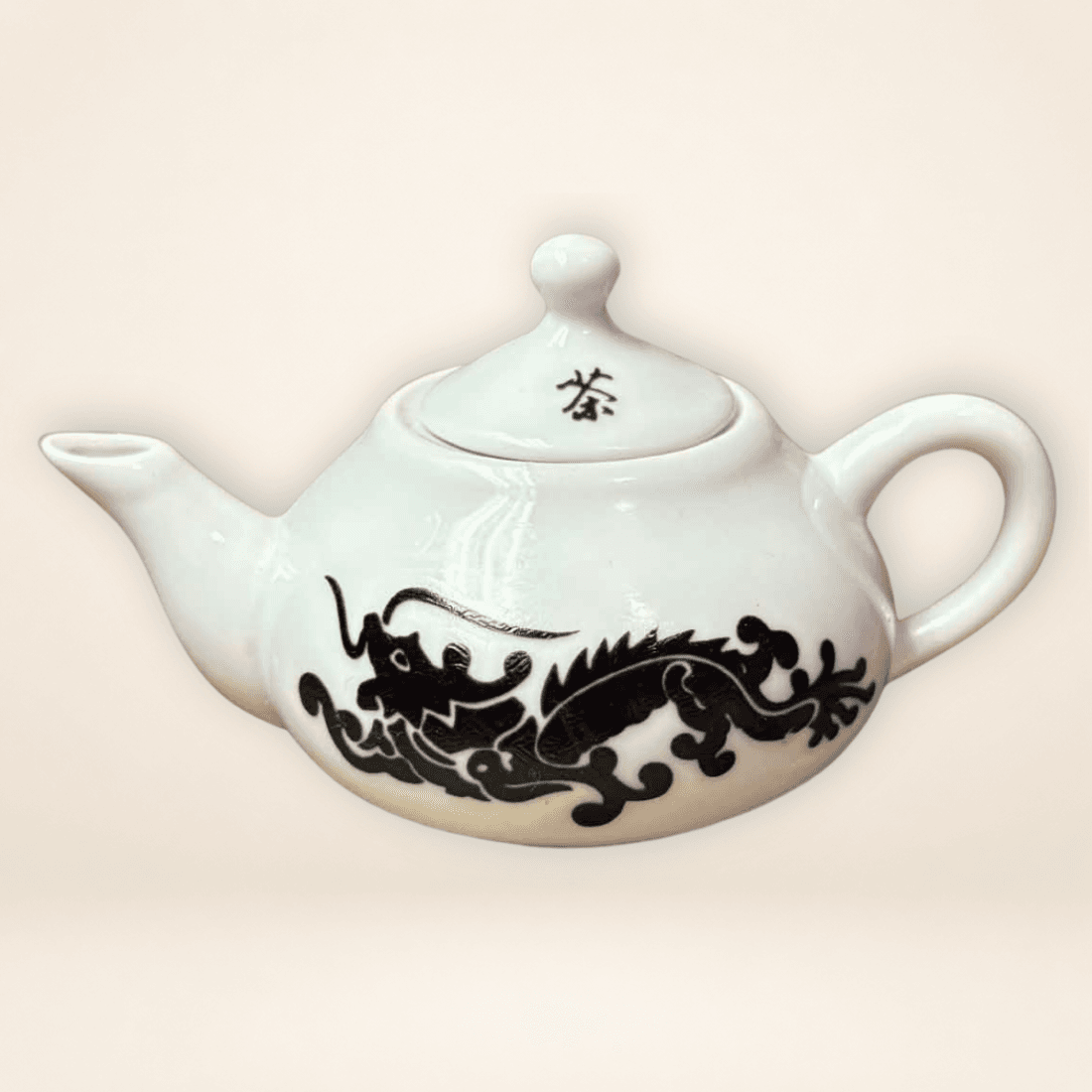 White miniature Chinese teapot with black dragon motif and lidded top