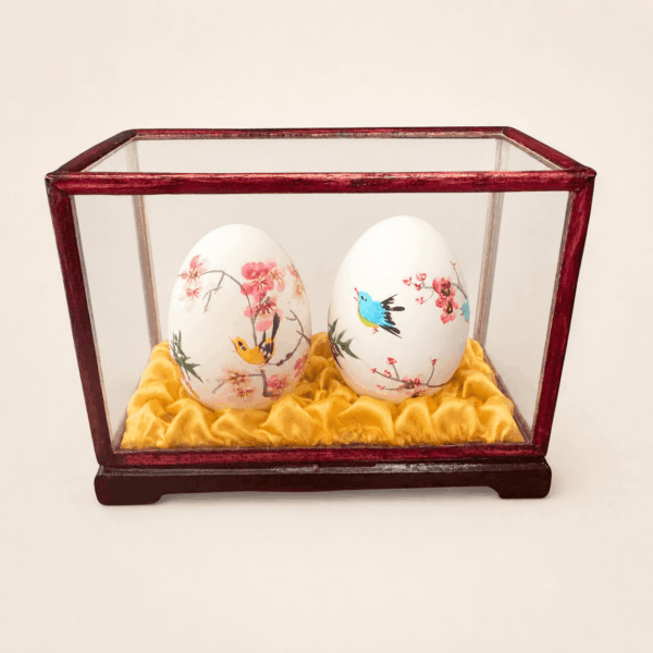 Vintage Chinese hand painted eggs in glass display case with bird and floral decoration