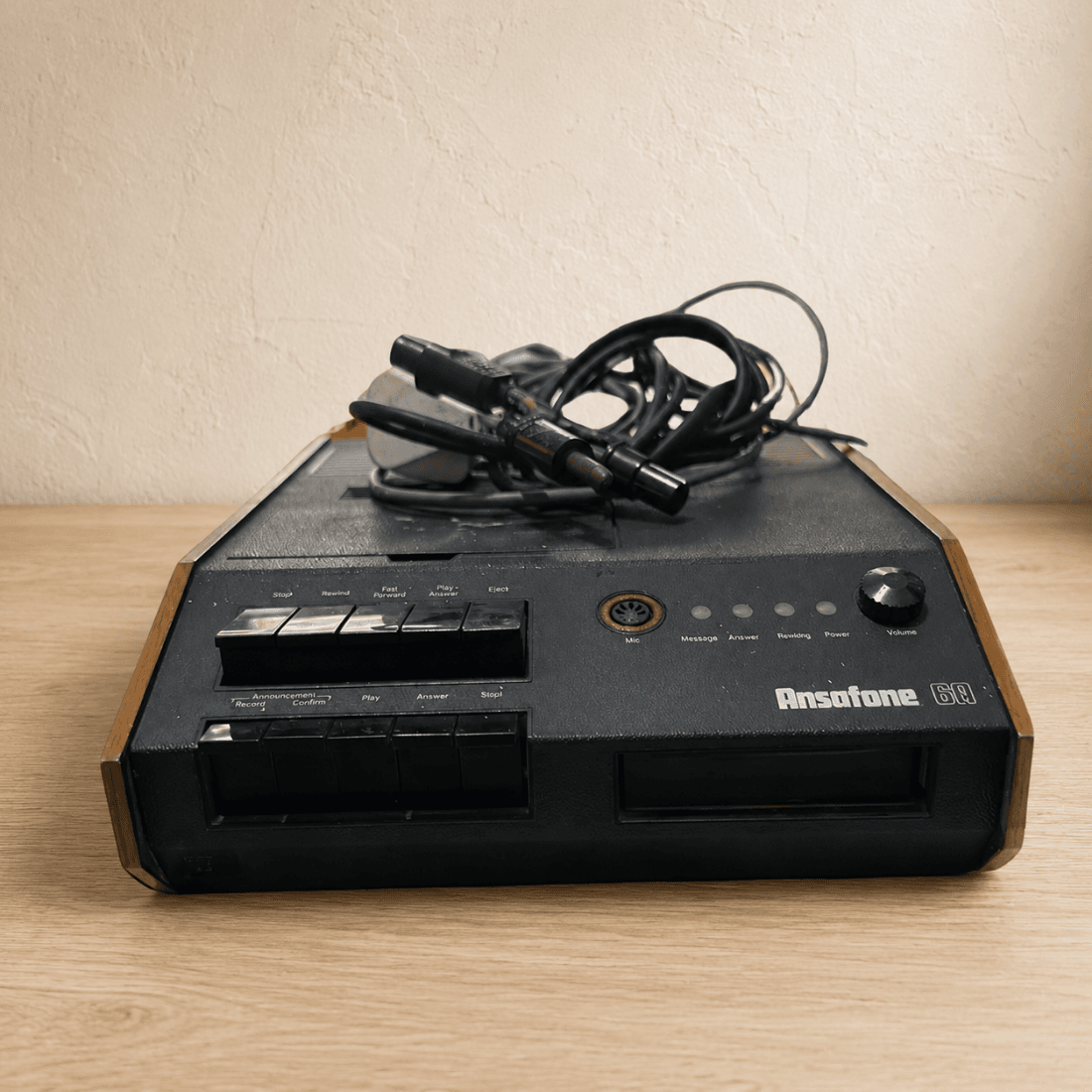 Low angle view of vintage Ansafone 6A telephone answering machine with period leads on top