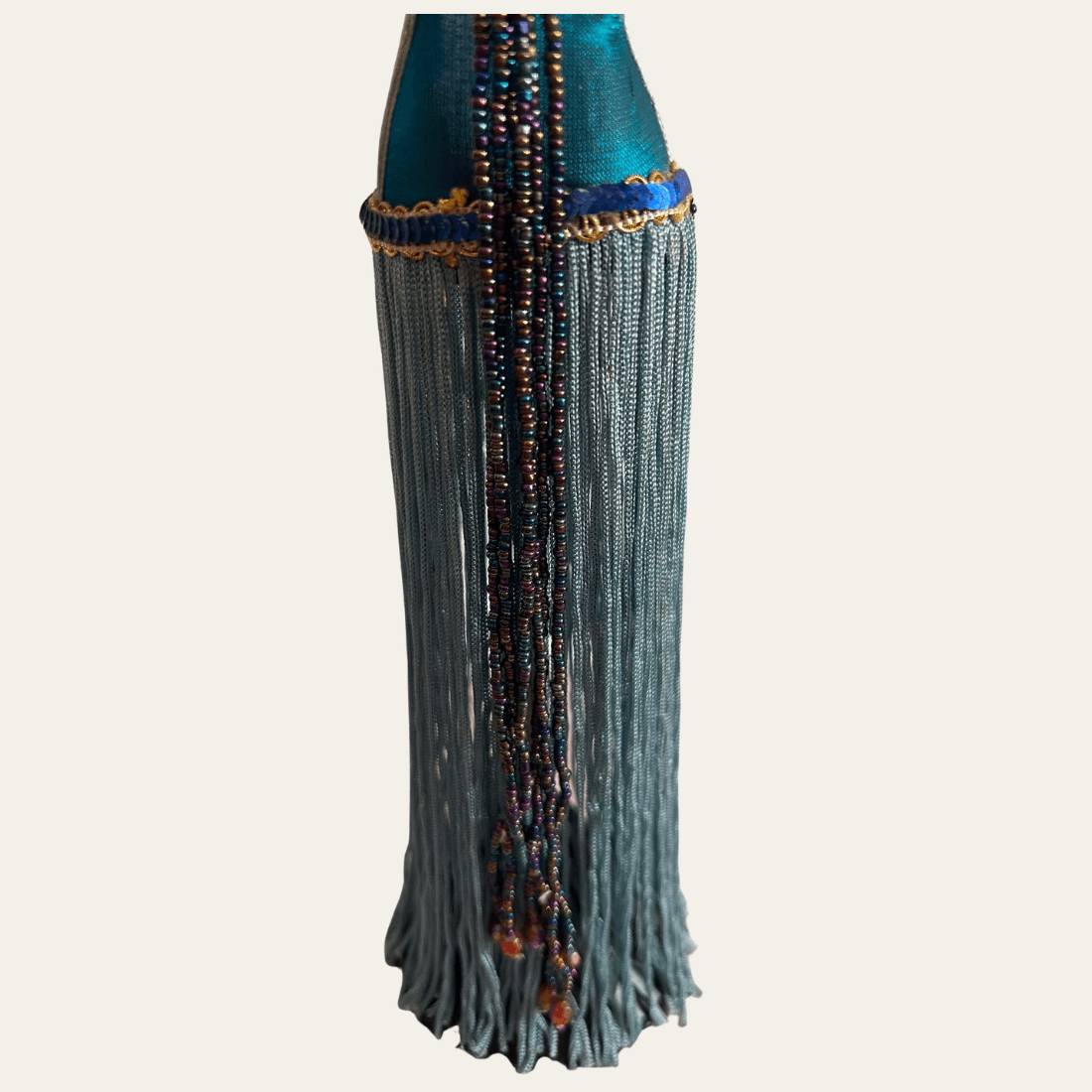 Blue fringe and multicoloured bead strands on mannequin jewellery stand