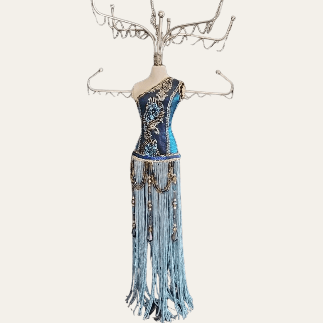 Blue beaded mannequin jewellery stand with silver-tone metal hooks and long fringe