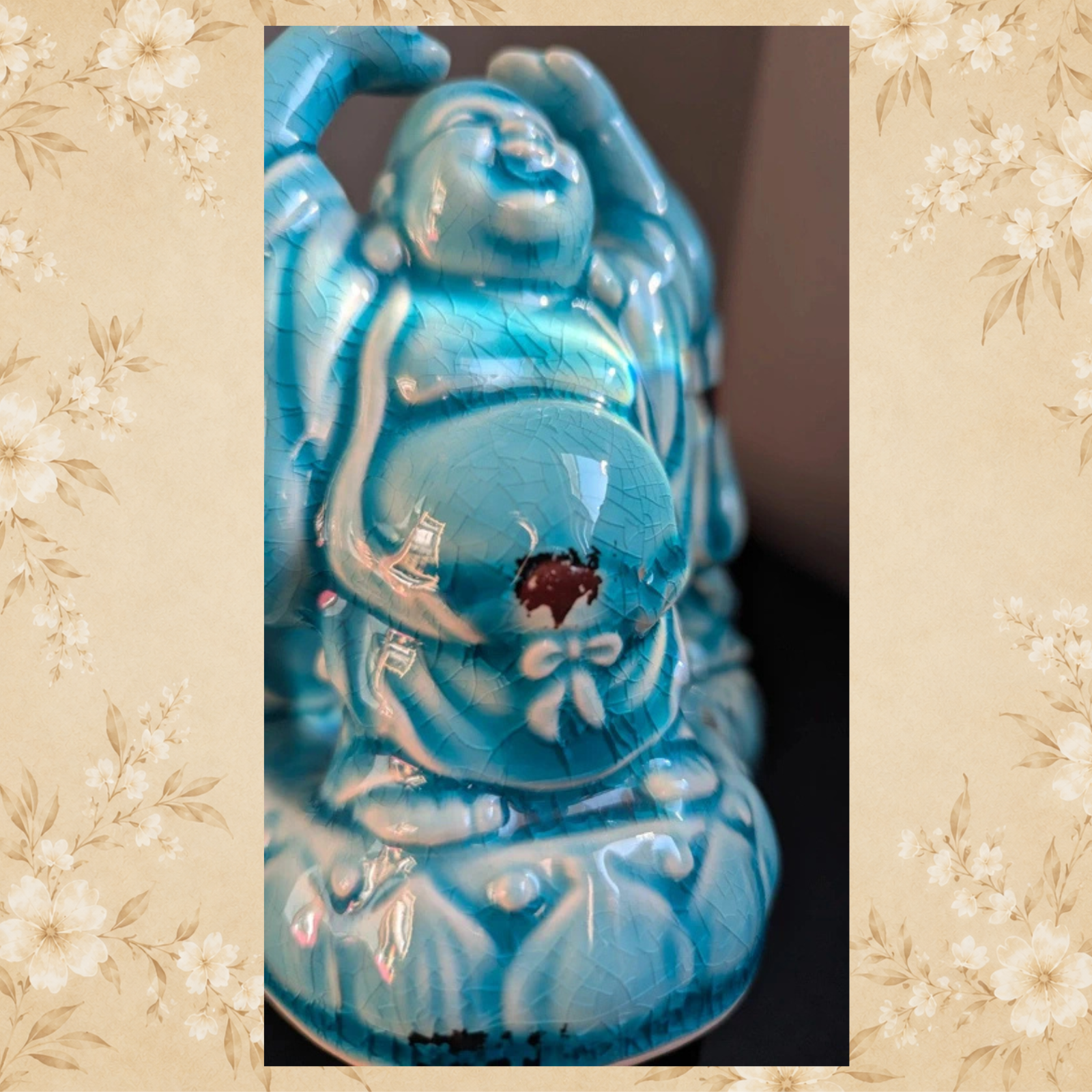 Side detail of turquoise ceramic Laughing Buddha candle holder