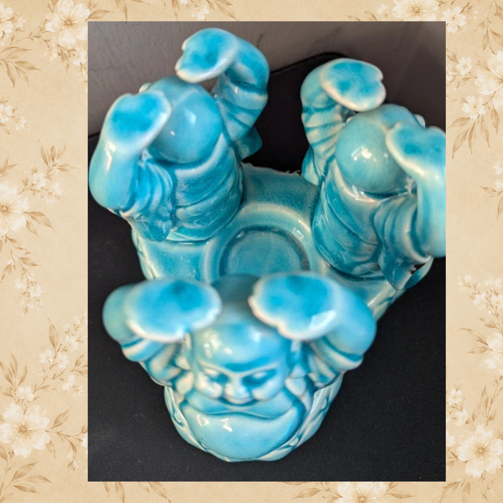 Top view of three Laughing Buddha figures surrounding candle holder opening