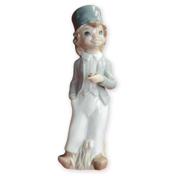 Casades boy figurine holding a pipe, with blue-grey hat and flowers at the base