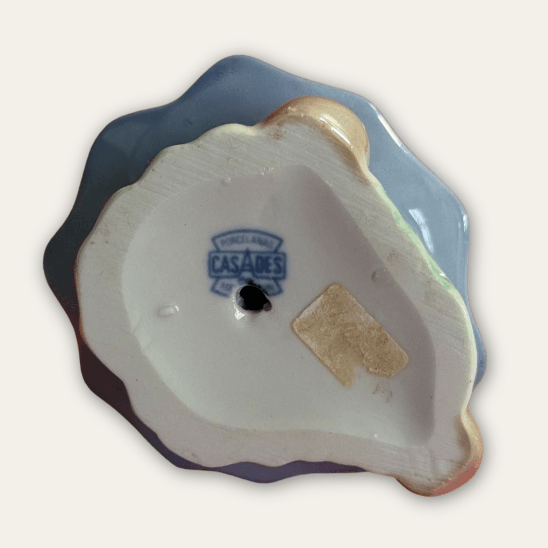 Underside of Casades porcelain figurine showing blue maker’s mark