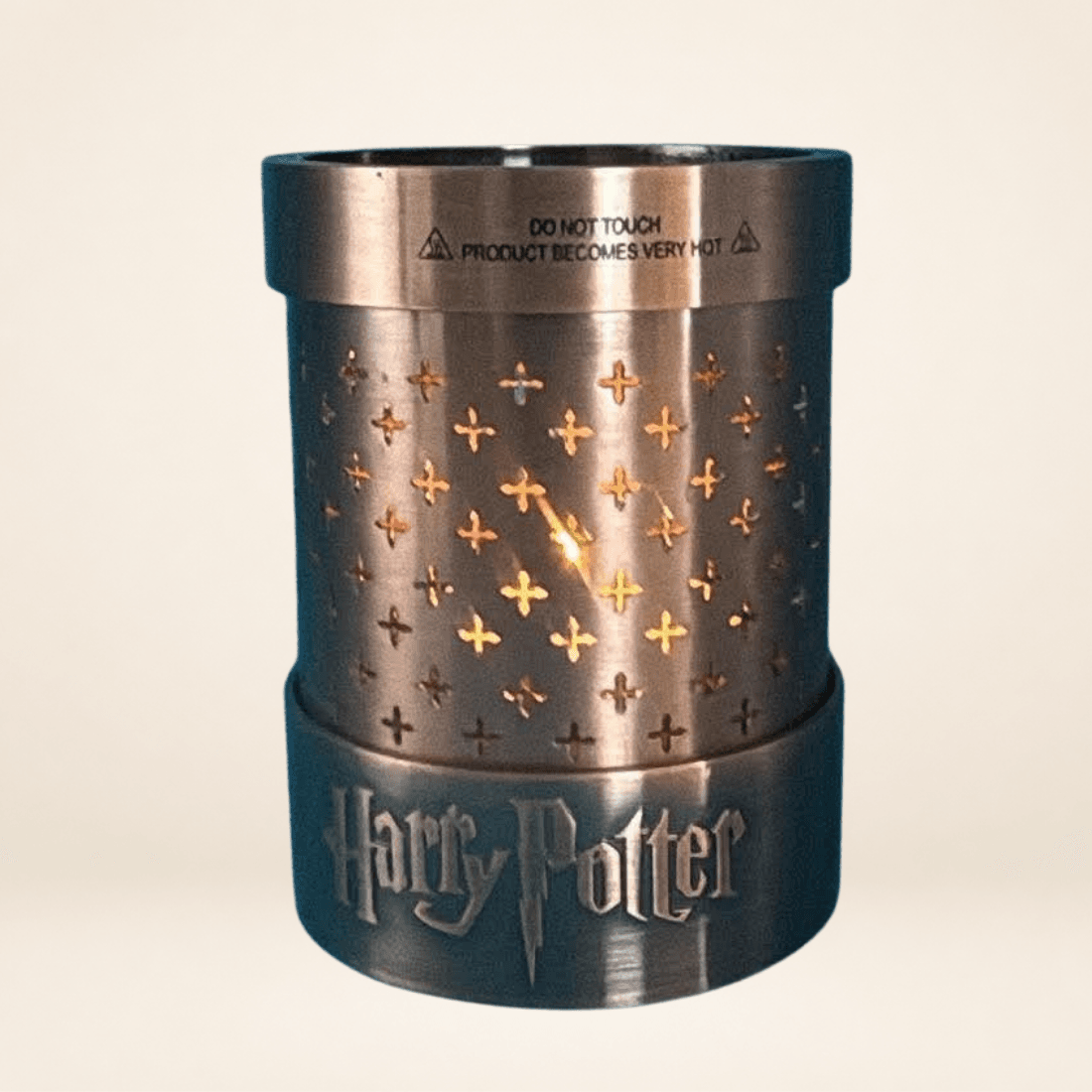 Harry Potter metal potion lamp base with lit tealight glowing through the perforated sides