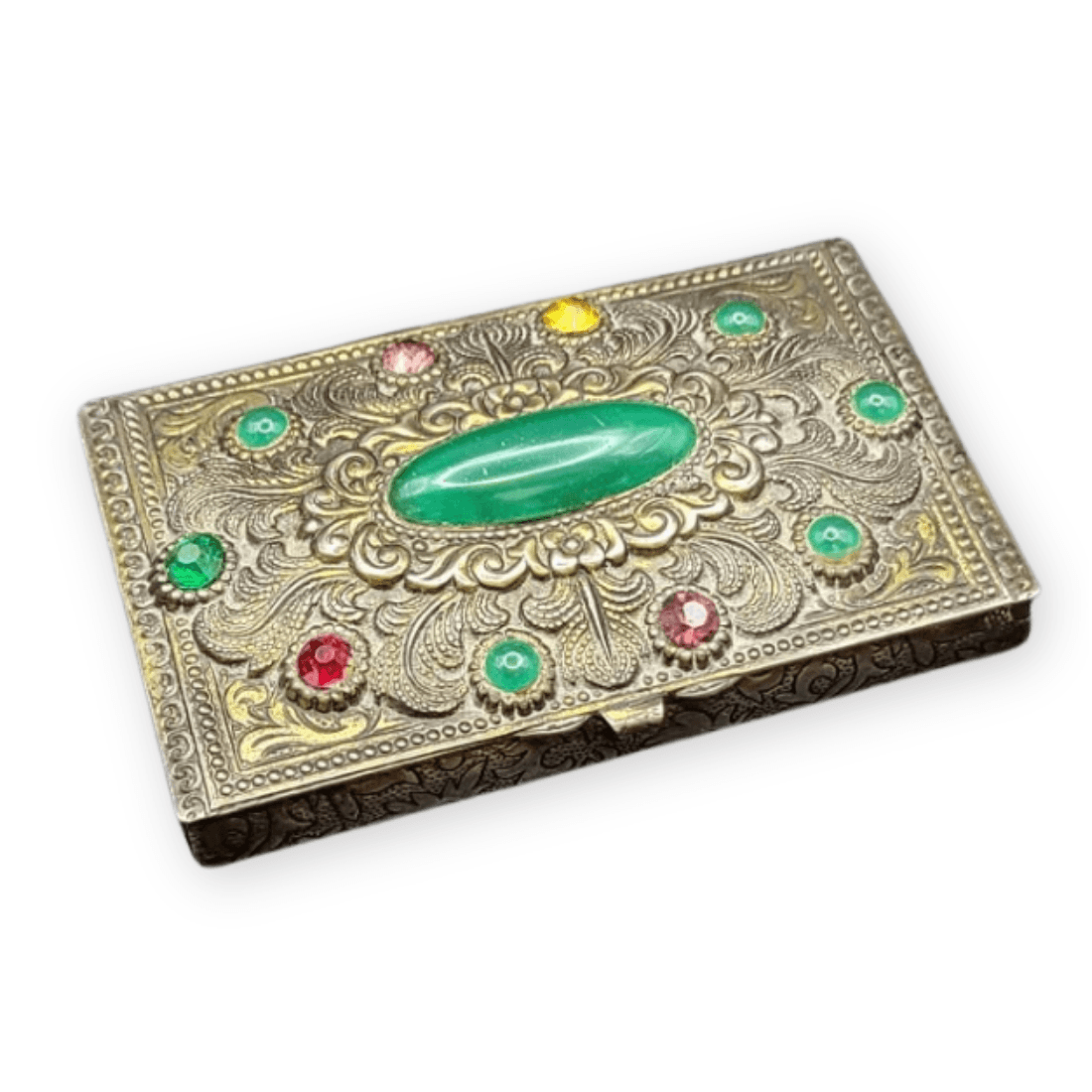 Jewelled trinket box with an oval green cabochon, colourful accents and raised floral metalwork