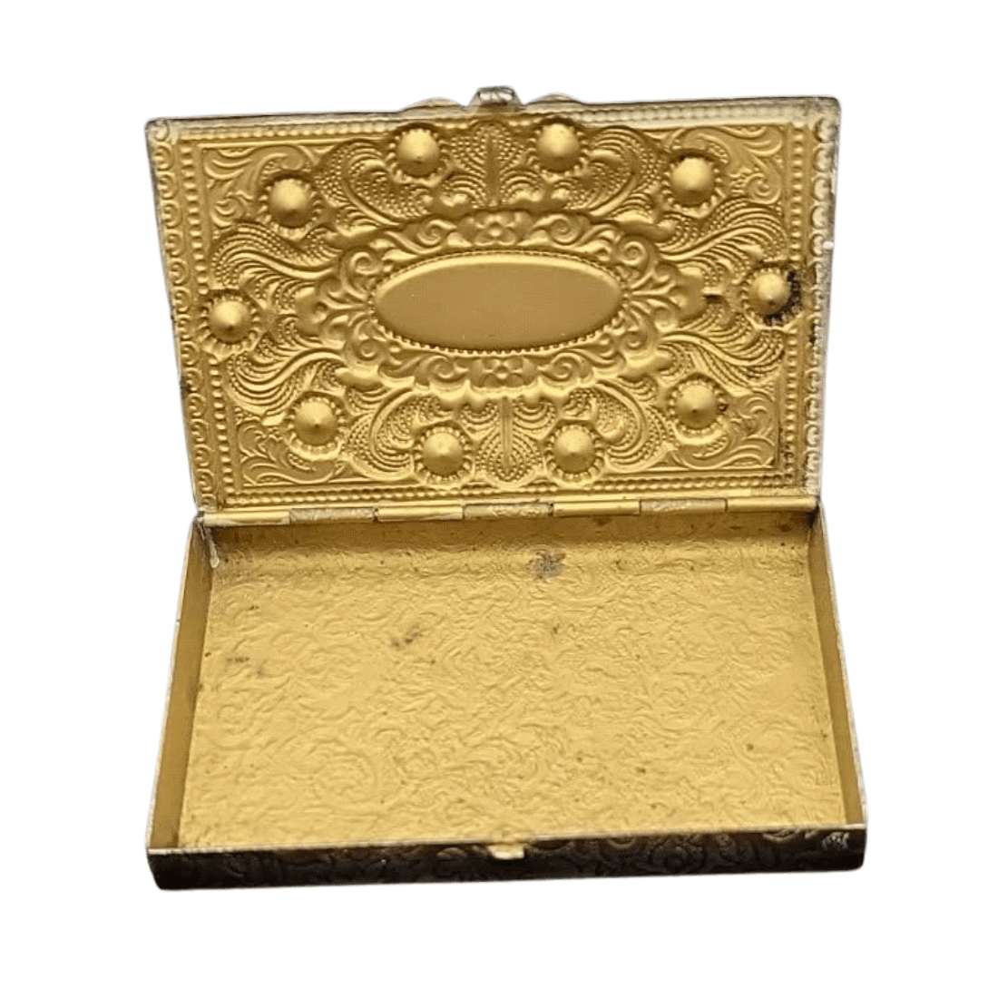 Open metal trinket box showing its gold-tone interior, hinge and dark surface marks