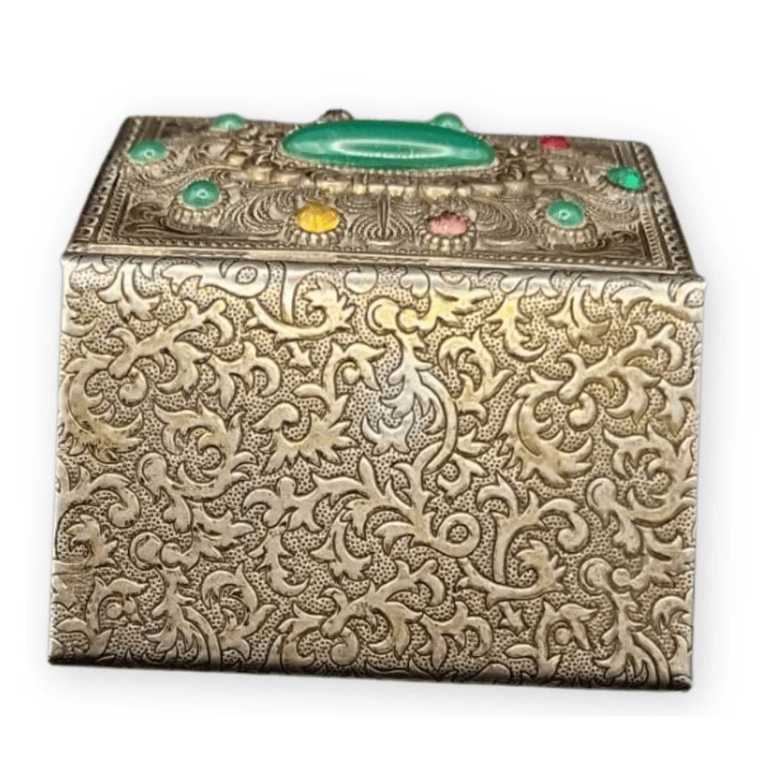 Patterned underside of the metal trinket box with dense floral scroll decoration