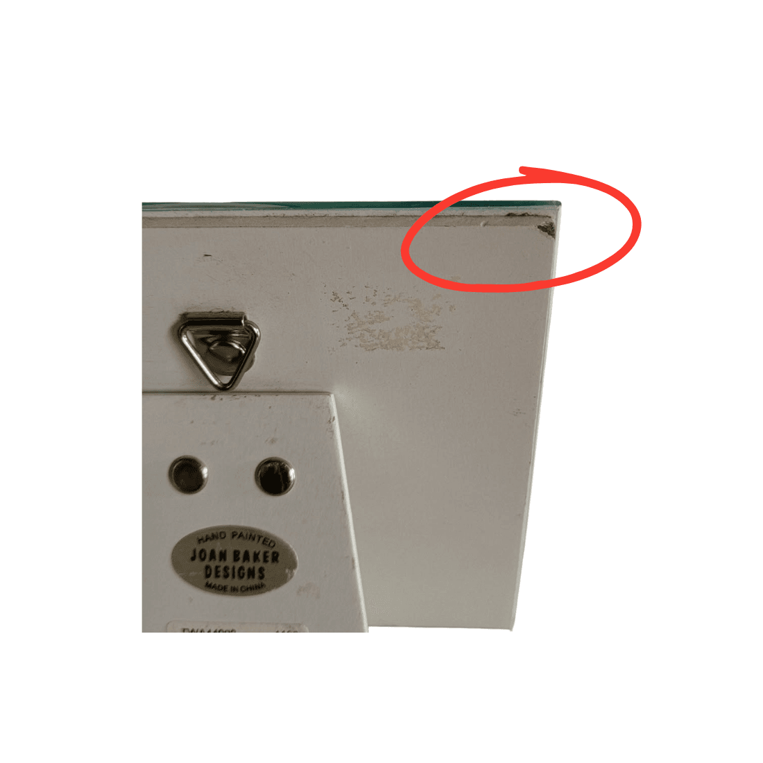 Red circle highlighting minor wear and lifting to the covering at the upper-right corner of the plaque backing