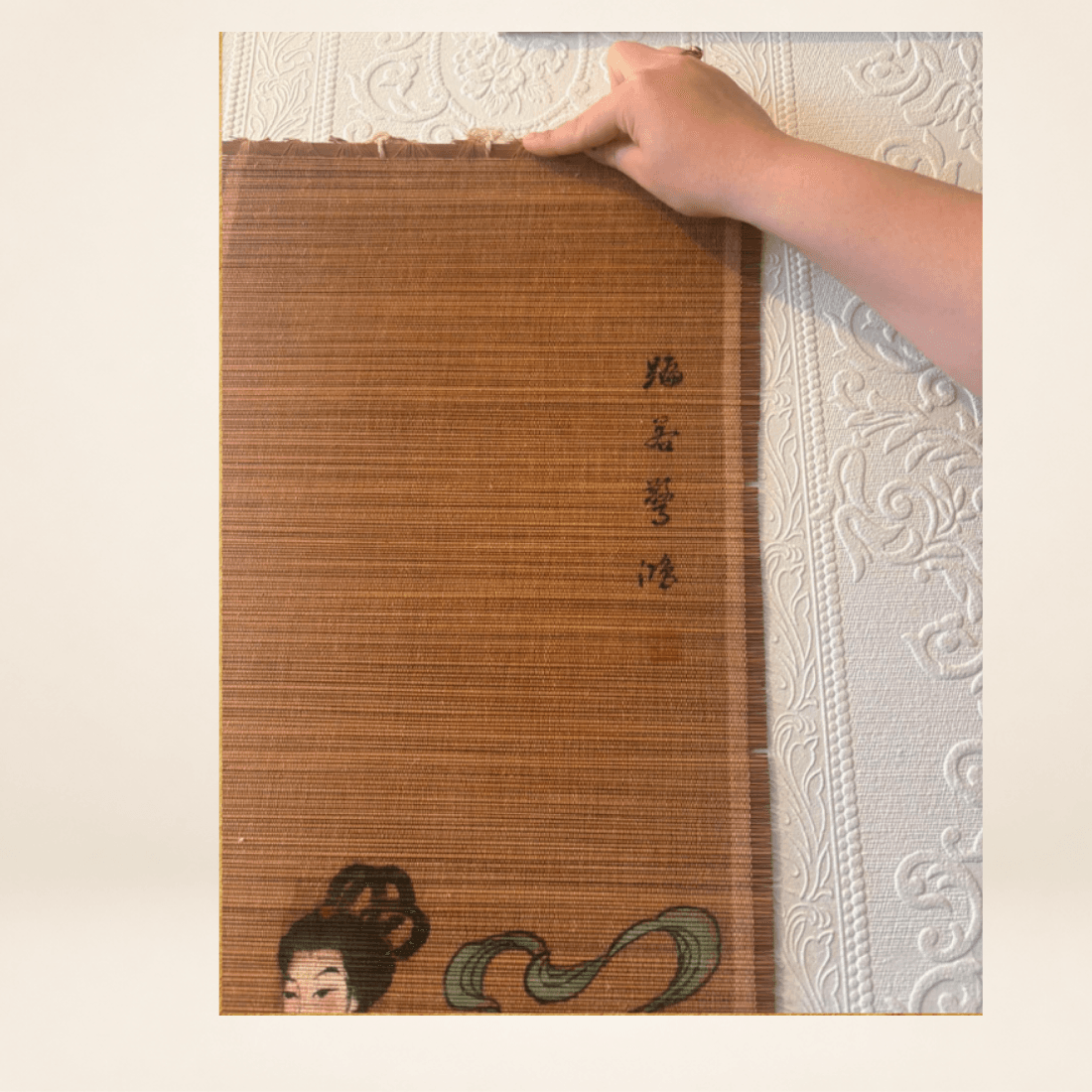 Close-up of vertical script and woven surface on vintage bamboo wall hanging