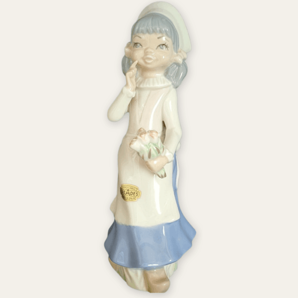 Vintage Casades porcelain figurine of a girl holding flowers, front view