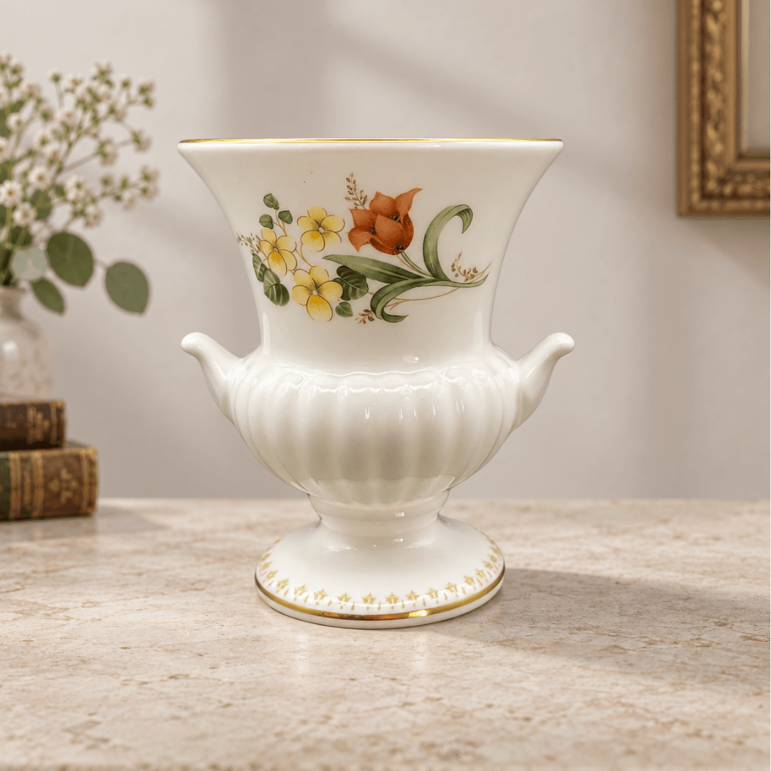 Styled display of a Wedgwood Mirabelle urn vase with floral decoration