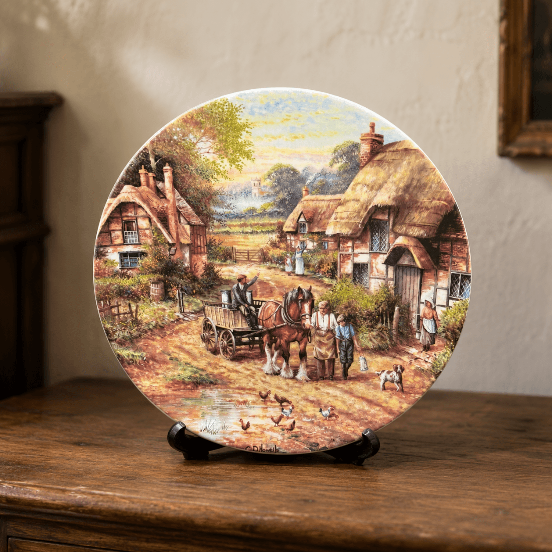 Early Morning Milk decorative plate displayed on a wooden cabinet with a rural cottage scene