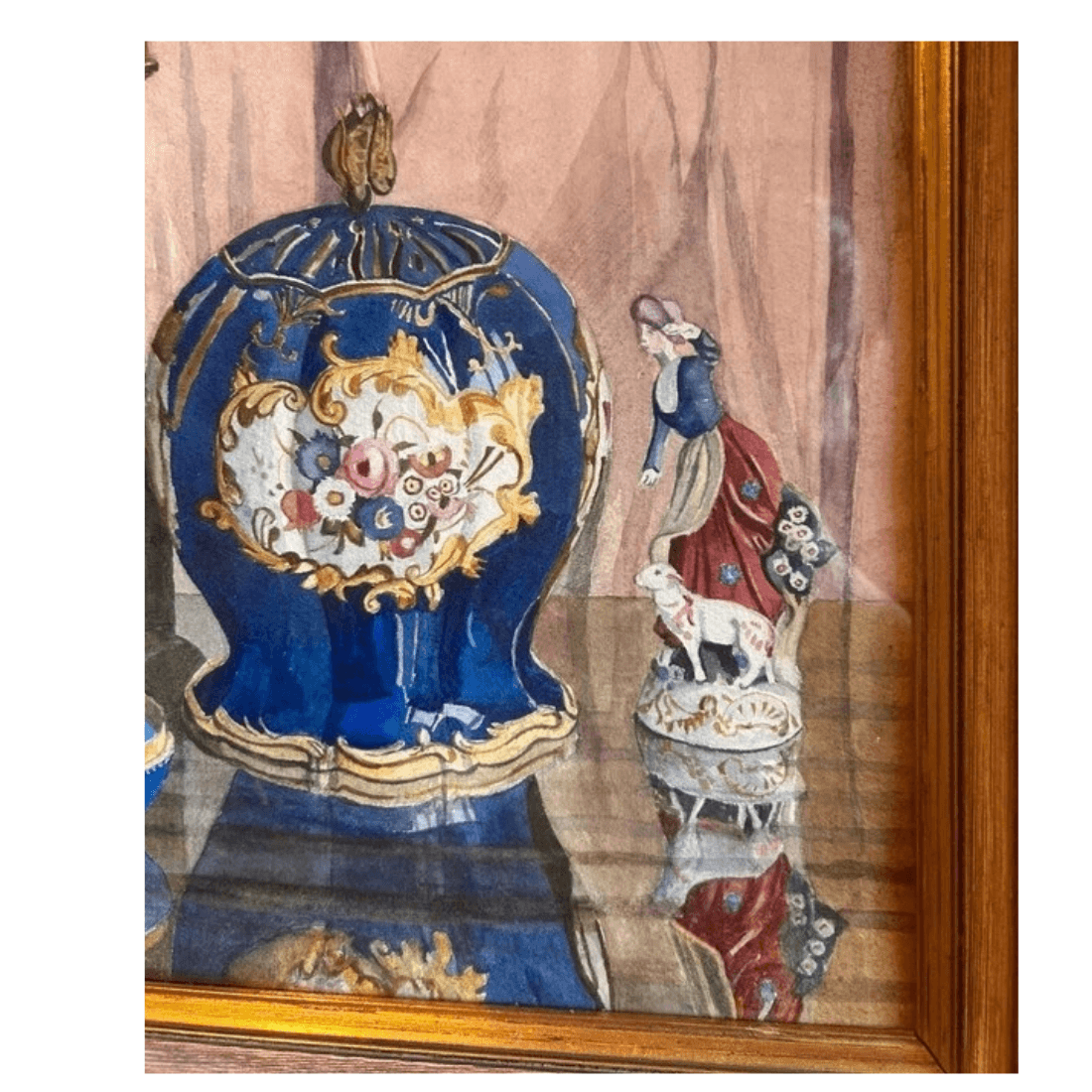 Watercolour detail showing a cobalt-blue floral ornamental jar beside a colourful female figurine with a small animal.